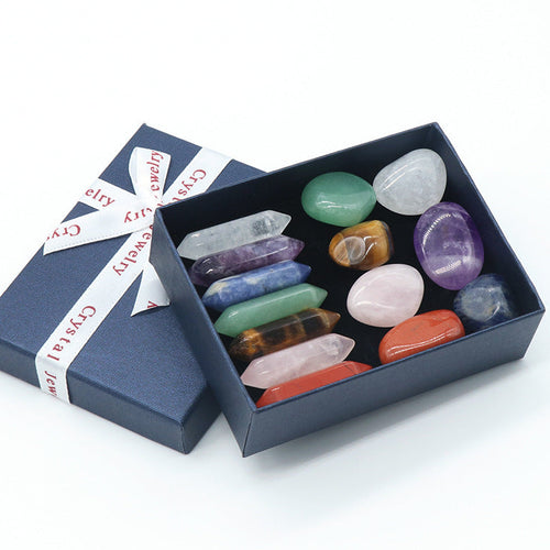 Set of colorful crystals in an open box with a branded ribbon on a white background